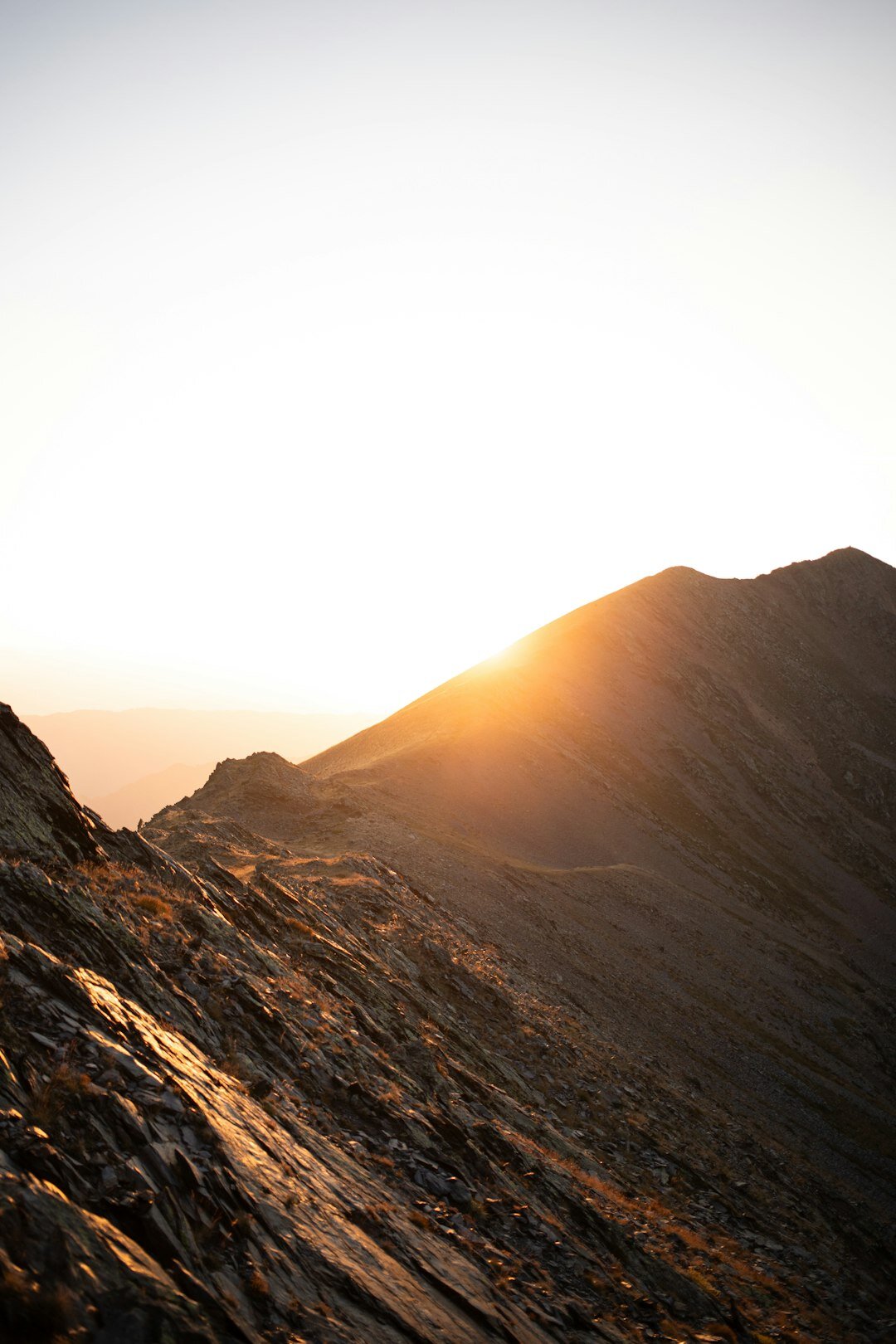 Silhouette of mountain ridges at golden hour sunset