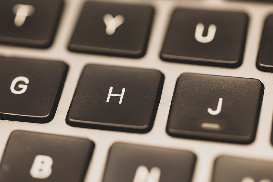 Close up of hands typing on a laptop keyboard